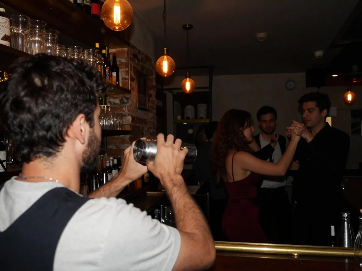 Bartender from behind shaking a cocktail in a warm-lit Athens bar with blurred costumed dancers behind.