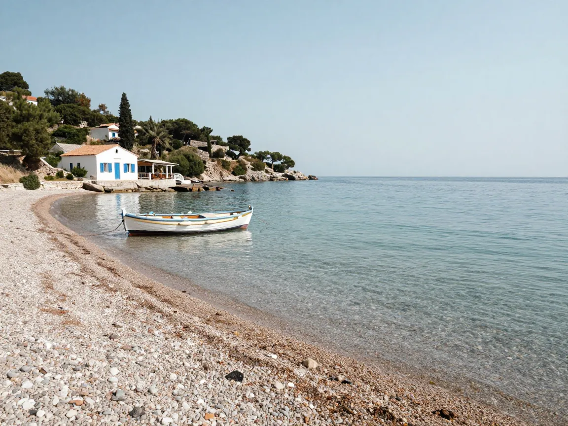 Quiet pebble bay with turquoise water and a whitewashed taverna on the Corfu coast